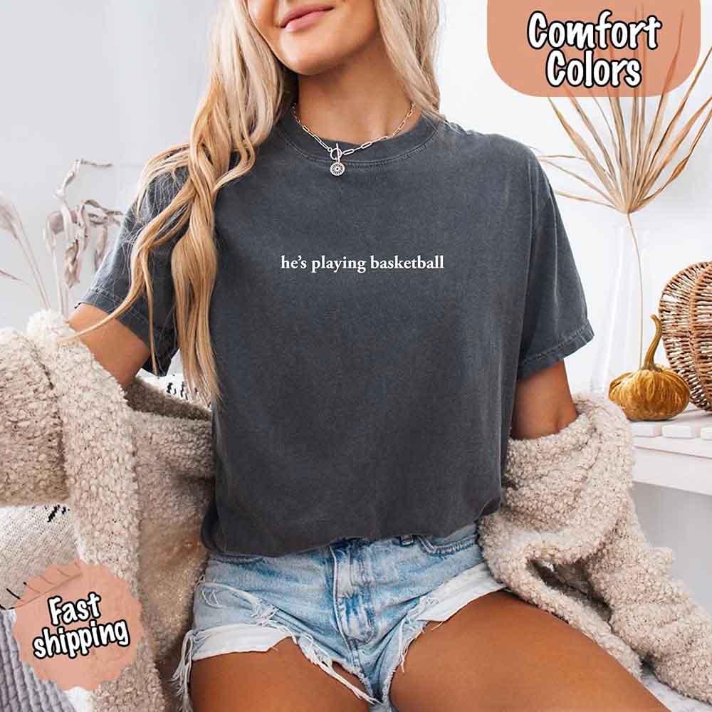 He’s Playing Basketball – Funny Sports Girlfriend Comfort Color Shirt for Women